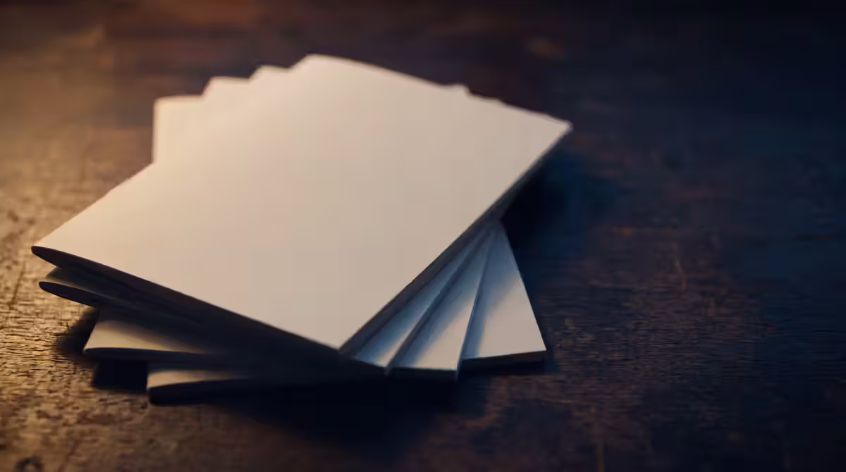A stack of printed study guides fanned across a desk